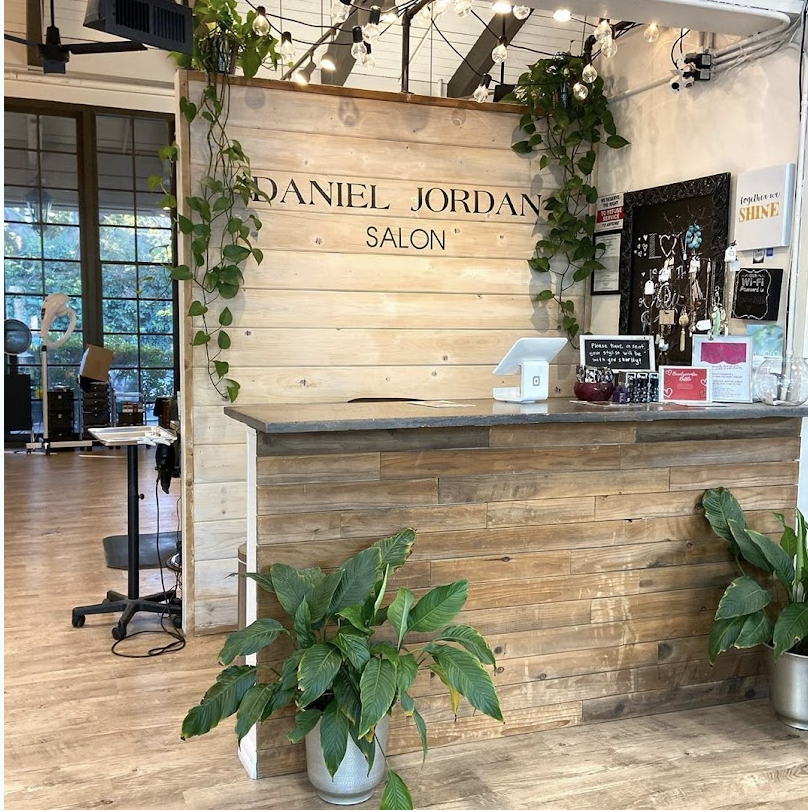 Warm salon reception with oak finishes.