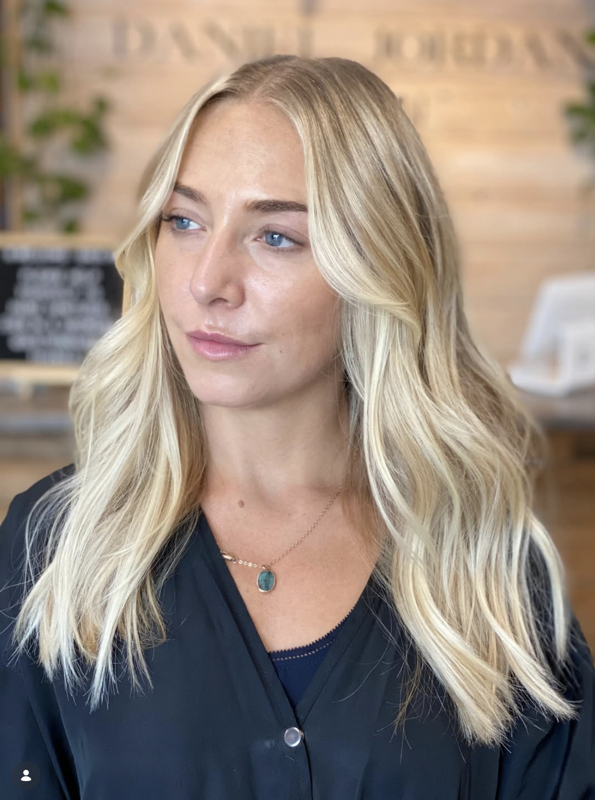 Client result with bright blonde waves and a soft seamless finish.